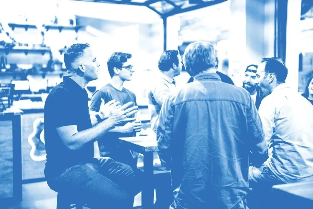 A group of friends in deep conversation around a table